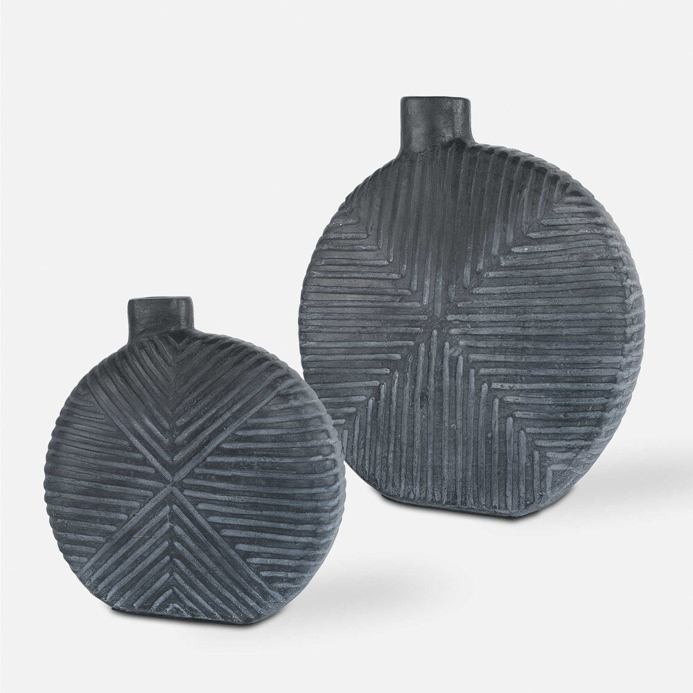 Set of two aged black vases with geometric carvings and off-centered openings, perfect for modern home decor and floral arrangements.