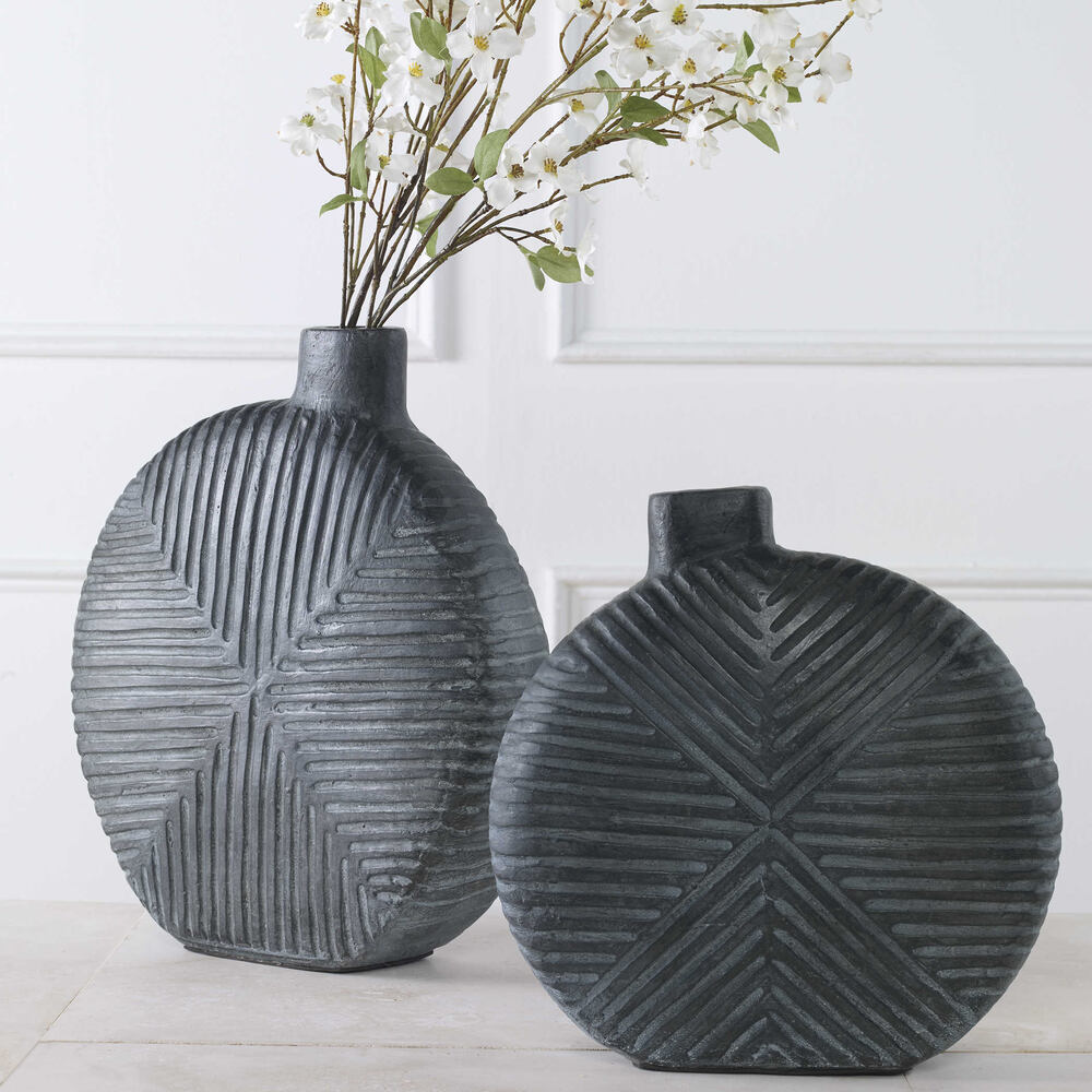 Modern aged black geometric vases with a unique carved design, adding a bold touch to any room or tabletop display.