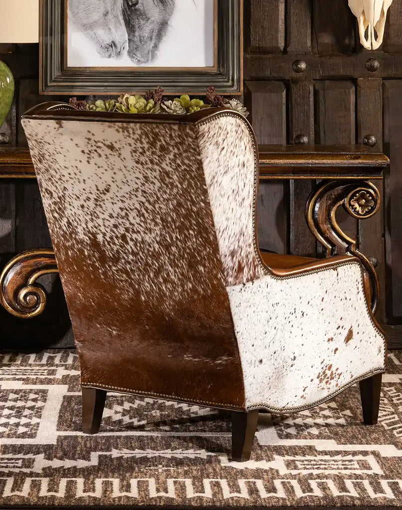 The back view of the Alanna Leather Chair featuring genuine cowhide upholstery and intricate brass nail tack detailing.