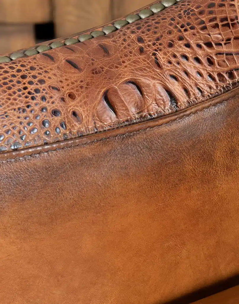 Detailed view of the embossed crocodile grain on the hand-burnished leather of the Allie Calexico Swivel Glider.