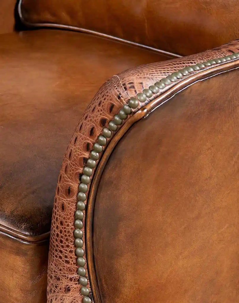 Side view of the embossed leather armrest on the Allie Calexico Swivel Glider, blending functionality with exotic sophistication.