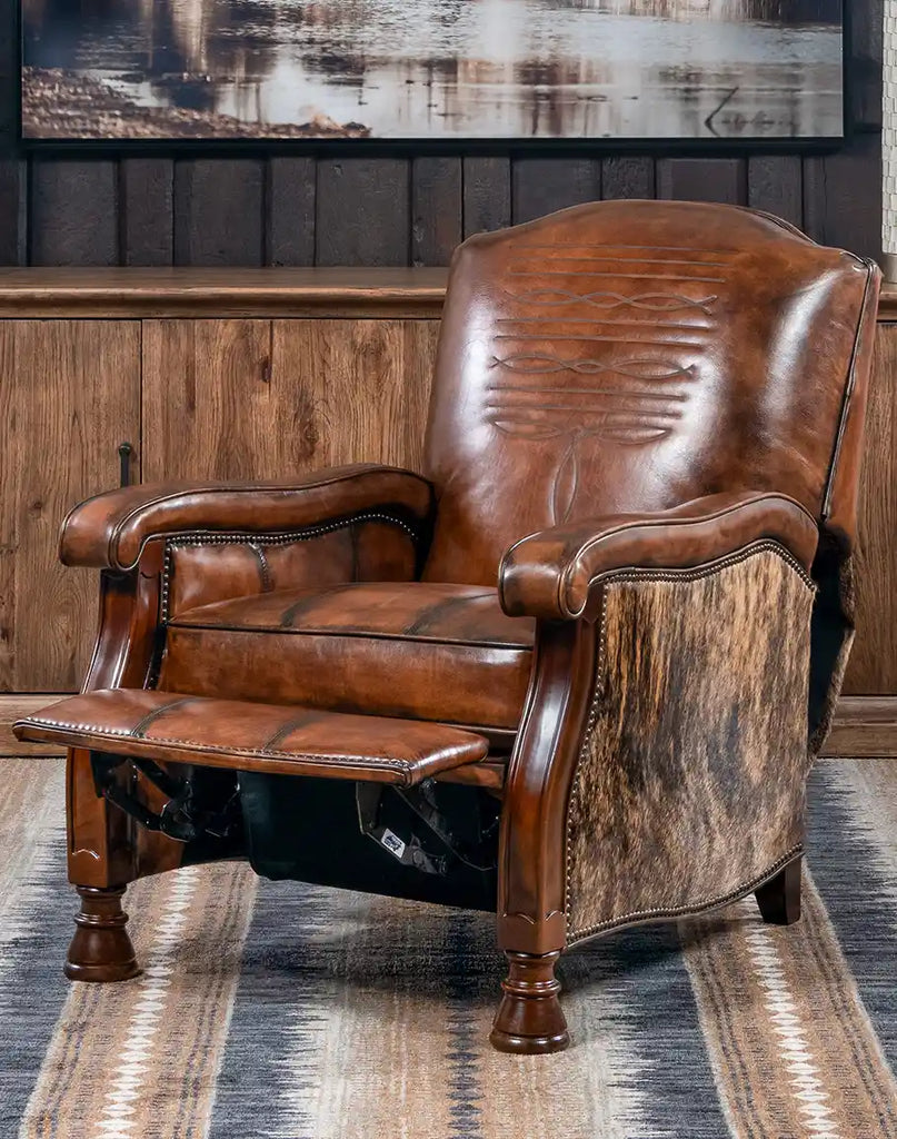 A front-facing view of the Ancestral Western Leather Recliner, showcasing its rich brown leather upholstery and detailed stitching.