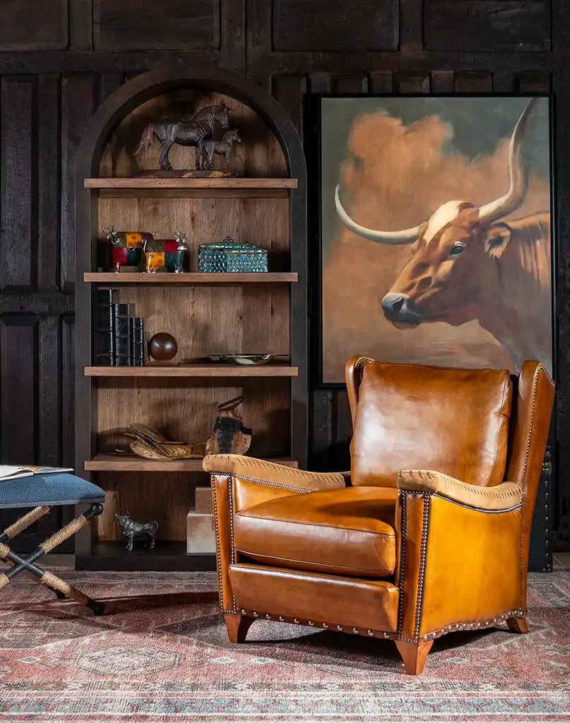 The Norseman Leather Chair positioned in a study room, highlighting its clean lines and sleek silhouette from an angled perspective.