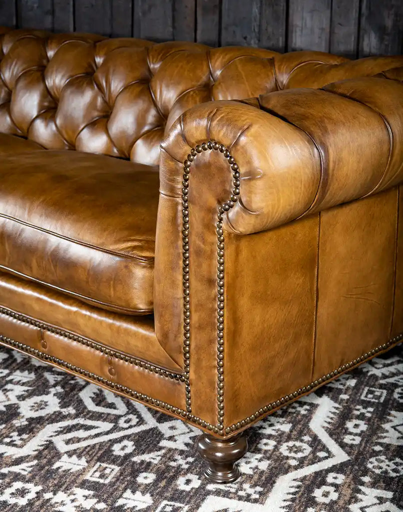 Angled view of the Nova Chesterfield Sofa emphasizing its craftsmanship and leather finish.