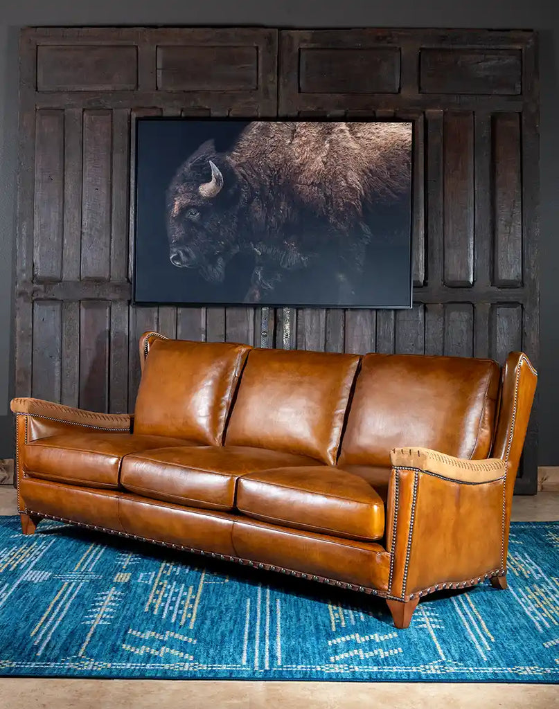 Angled perspective of the Norse Leather Sofa styled in a cozy living room, emphasizing its sleek silhouette and modern elegance.