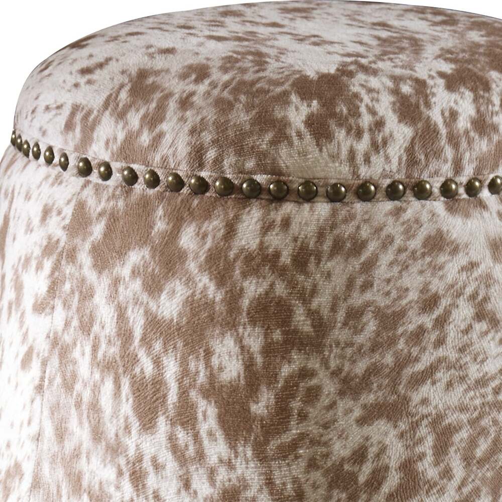 Elegant faux cowhide ottoman in chestnut tones with brass nailhead accents for a stylish touch.
