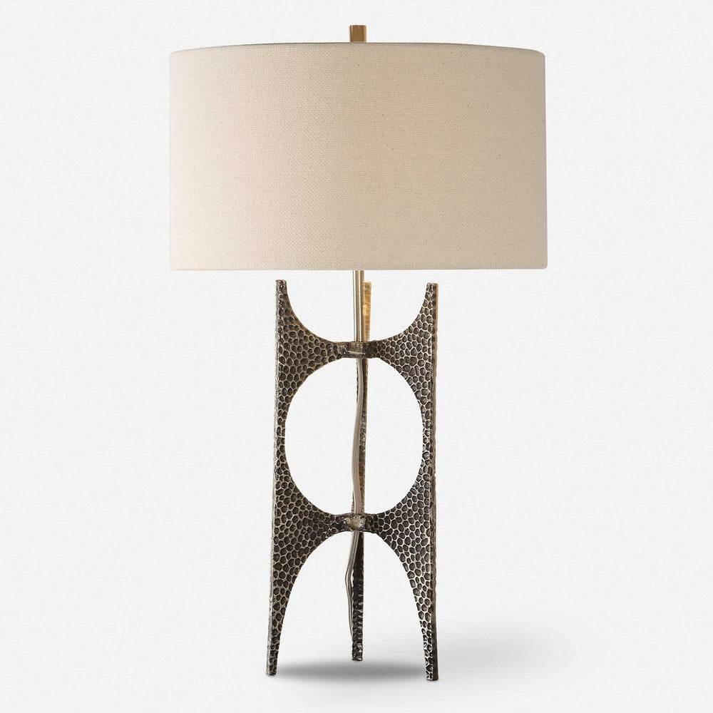 Stylish table lamp with an antiqued golden bronze base, hammered texture, and a white linen shade, perfect for modern decor.