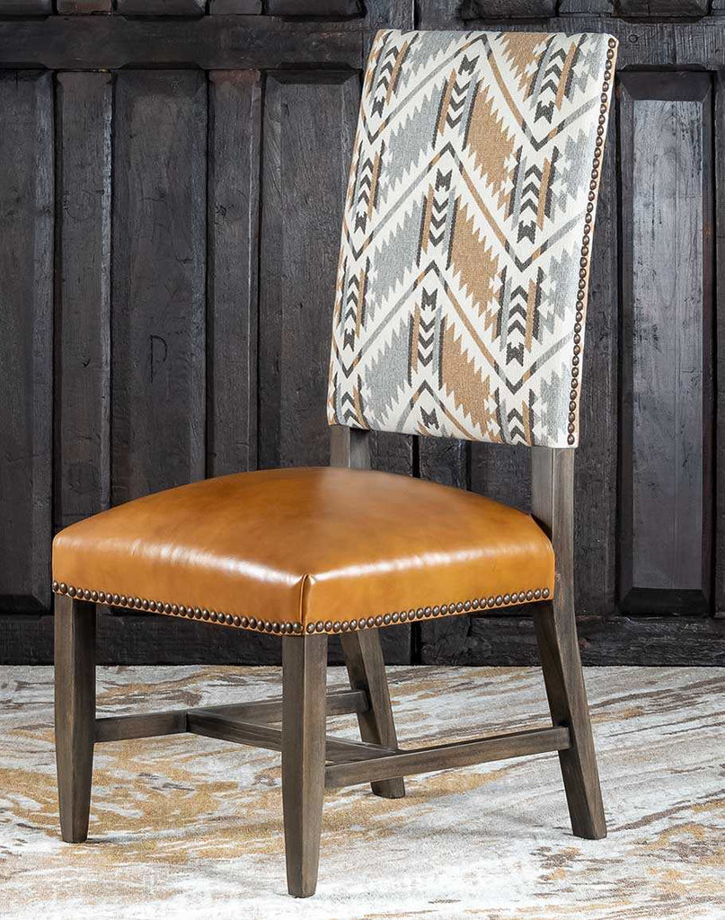 Appalachian Dining Chair showcasing its geometric back design and saddle tan leather seat.