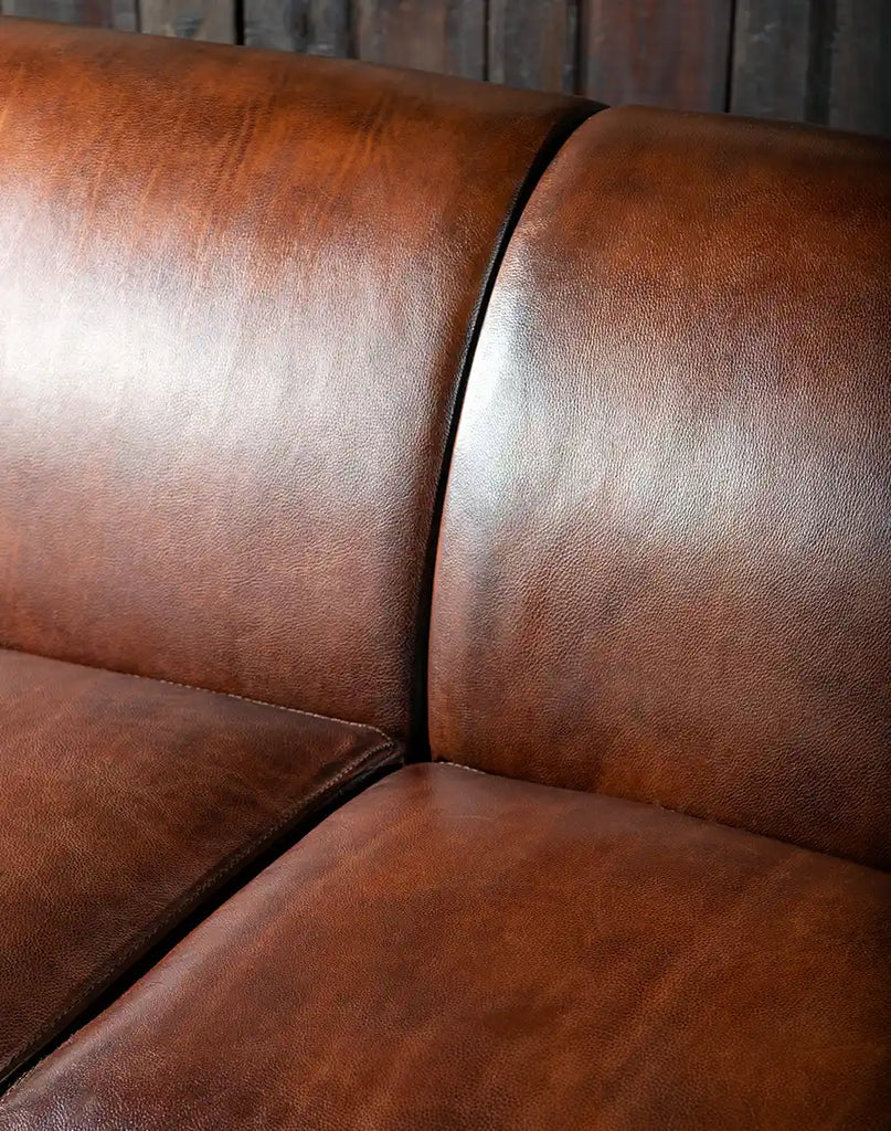 Detailed close-up of the full-grain and Nubuck leather upholstery, showcasing the texture and quality of the materials used.