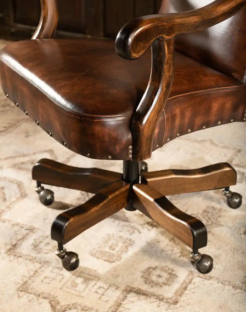 Detailed close-up of the armrests on the Arianna Office Chair, showcasing the hand-antiqued brown leather and fine stitching.