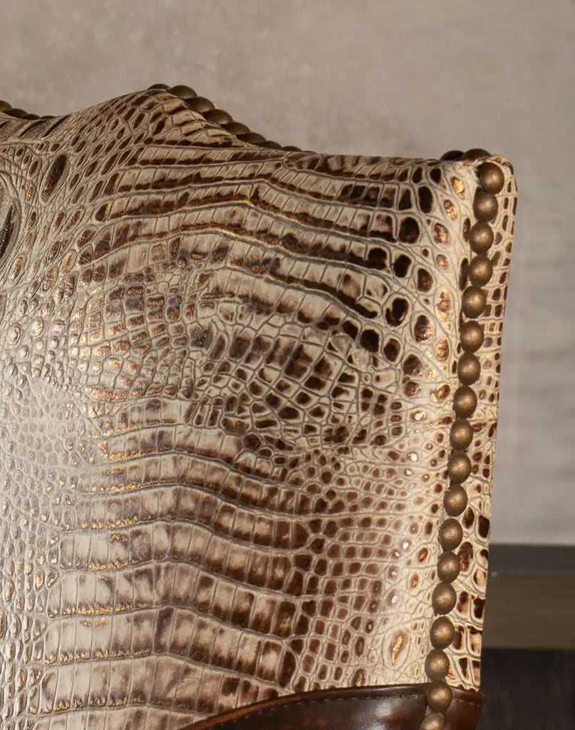 Detailed close-up of the embossed crocodile pattern yoke in ivory, chocolate, and gold tones on the Arianna Office Chair.