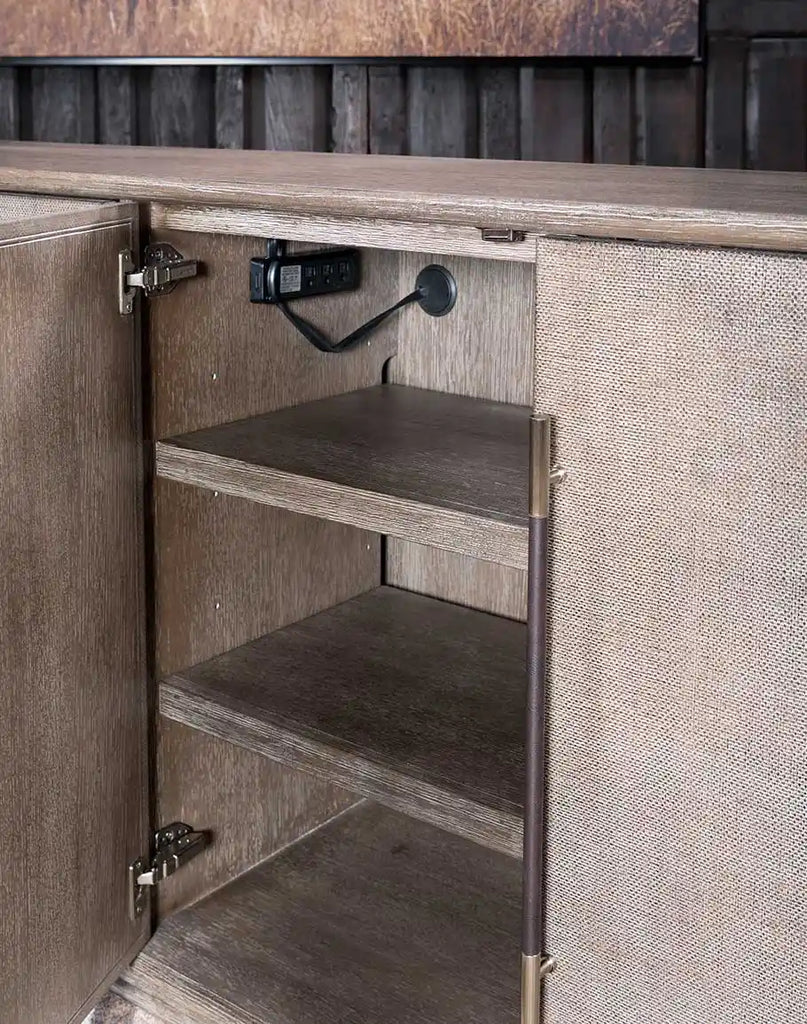 The Ashton Media Console with its doors open, revealing spacious storage compartments with adjustable wooden shelves.