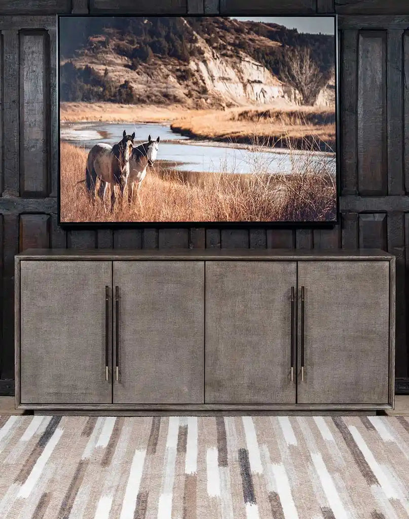 A front-facing view of the Ashton Media Console, showcasing its rich Mink finish, raffia-wrapped doors, and elegant leather-wrapped bar pulls.