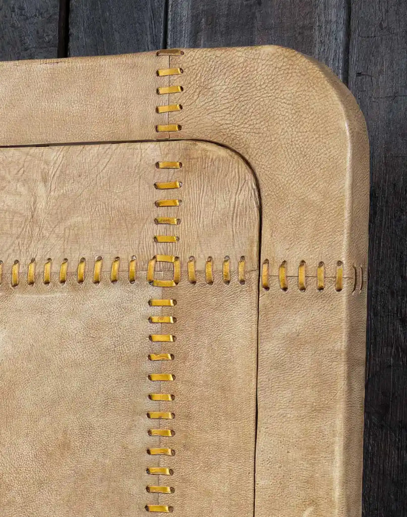 Detailed close-up of the leather-upholstered headboard on the Aurora Sand Leather Bed, showcasing its plush texture and finely stitched detailing.