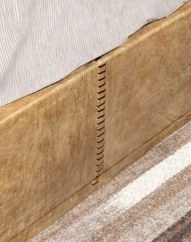 Detailed view of the sand-finished wood frame of the Aurora Sand Leather Bed, showcasing its natural grain and rustic charm.