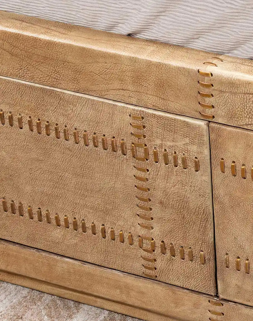 Close-up of the footboard on the Aurora Sand Leather Bed, featuring a solid wood frame in a rustic sand finish and precise craftsmanship.