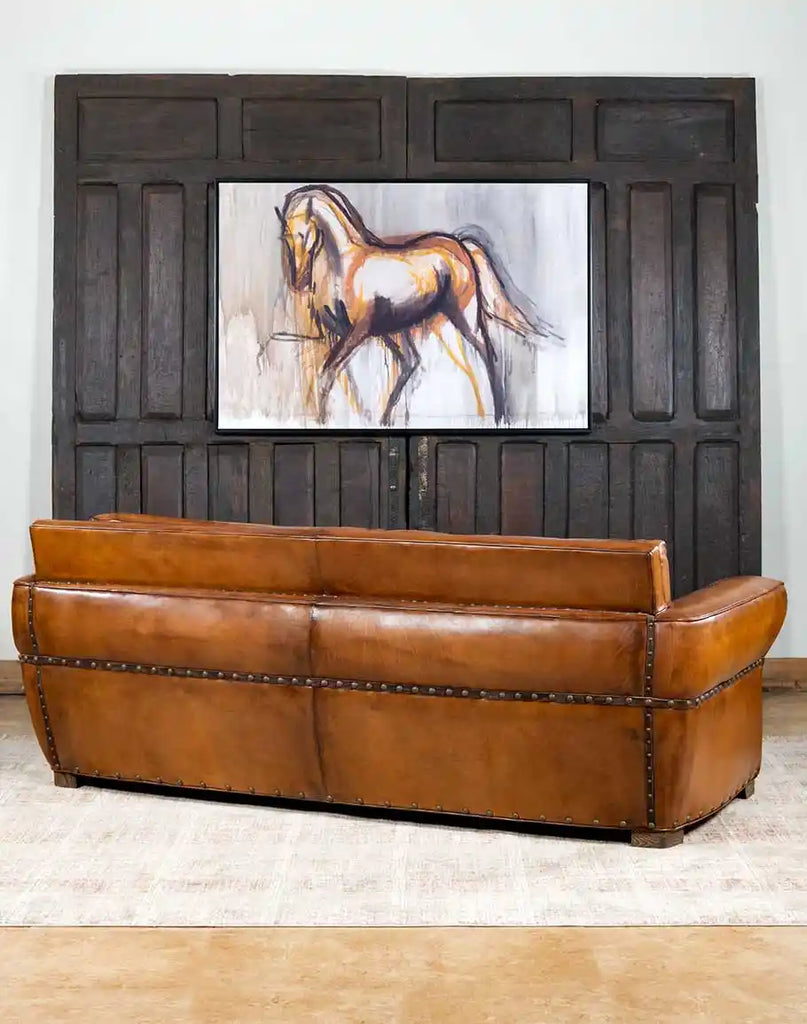 Back view emphasizing the seamless leather craftsmanship and refined ranch style of the Herdsman Sofa.