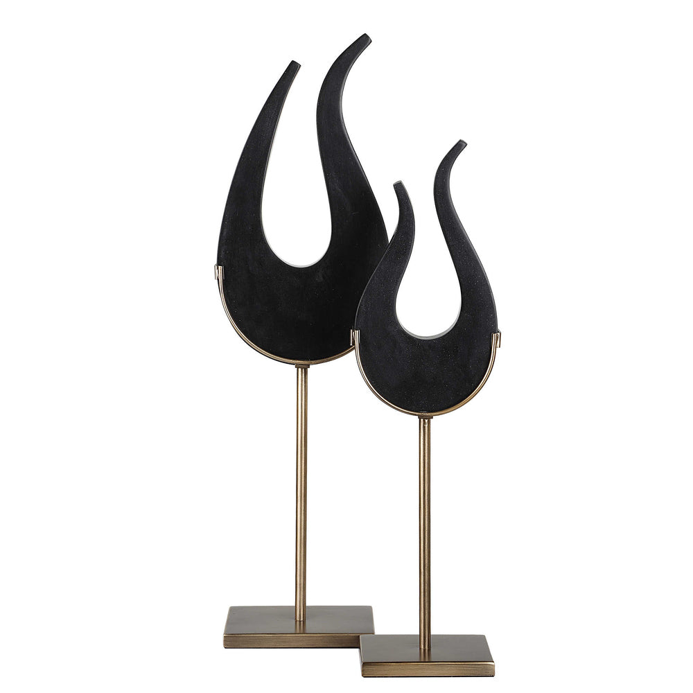 Modern Black Flame sculptures featuring black stone and elegant brushed brass stands in two sizes.