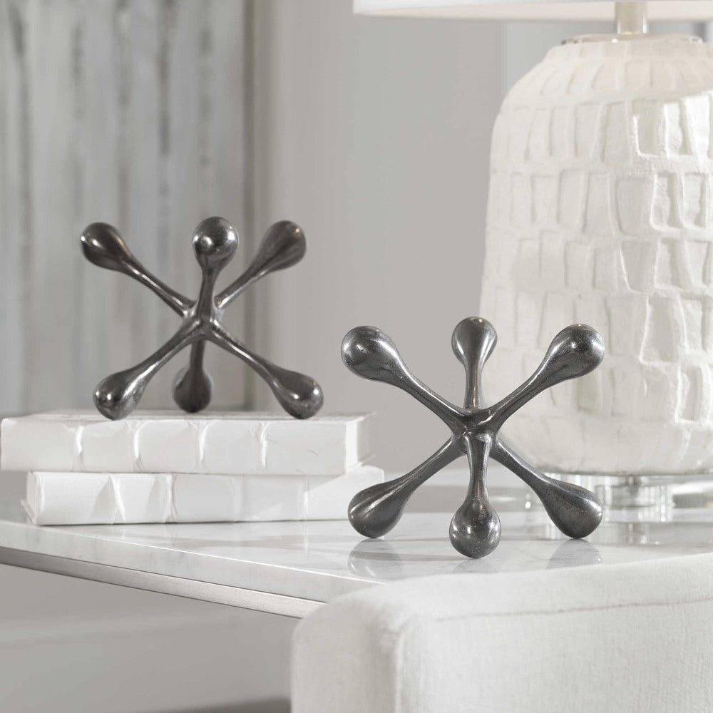 Sleek black nickel decorative objects crafted from durable cast aluminum with a modern design.