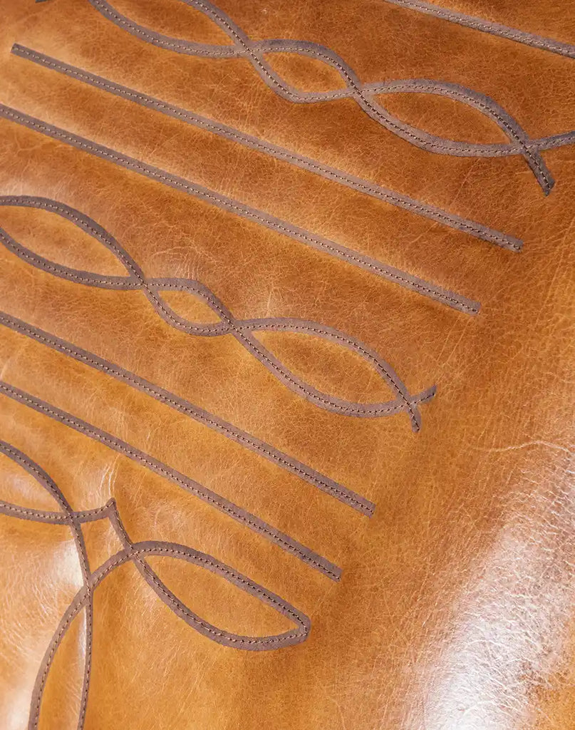 Detailed view of the cowboy boot stitched emblem on the inside back of the Bourbon Barrel Swivel Chair.