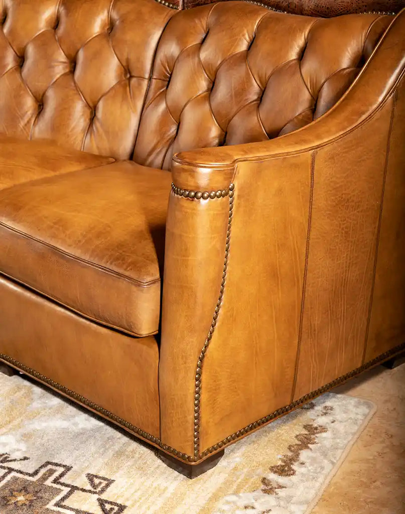 Highlight of the durable top-grain leather construction on the Brandon Tufted Leather Sofa, ensuring lasting quality.