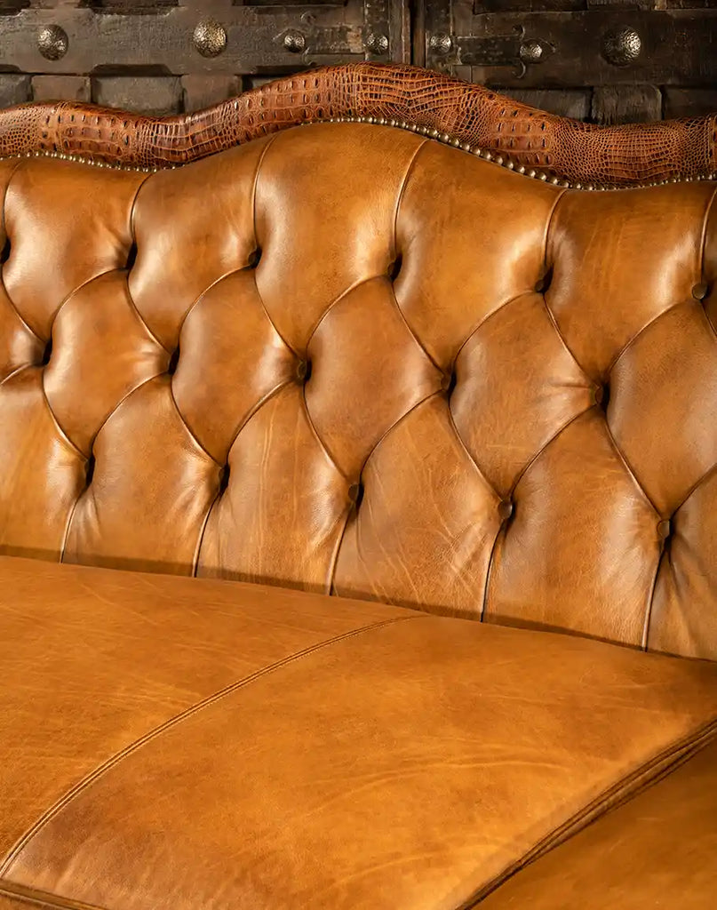 Close-up of the hand-colored and aged leather finish on the Brandon Tufted Leather Sofa for a unique and customizable look.