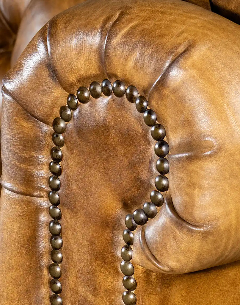 A close-up showing the brass nailhead accents on the armrests of the Nova Chesterfield Sofa.