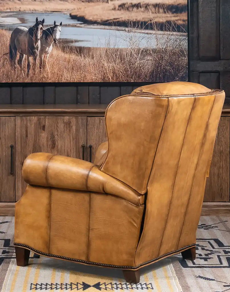 Rear perspective of the Bravo Westworth Recliner, showcasing its seamless leather craftsmanship and brass nailhead trim.