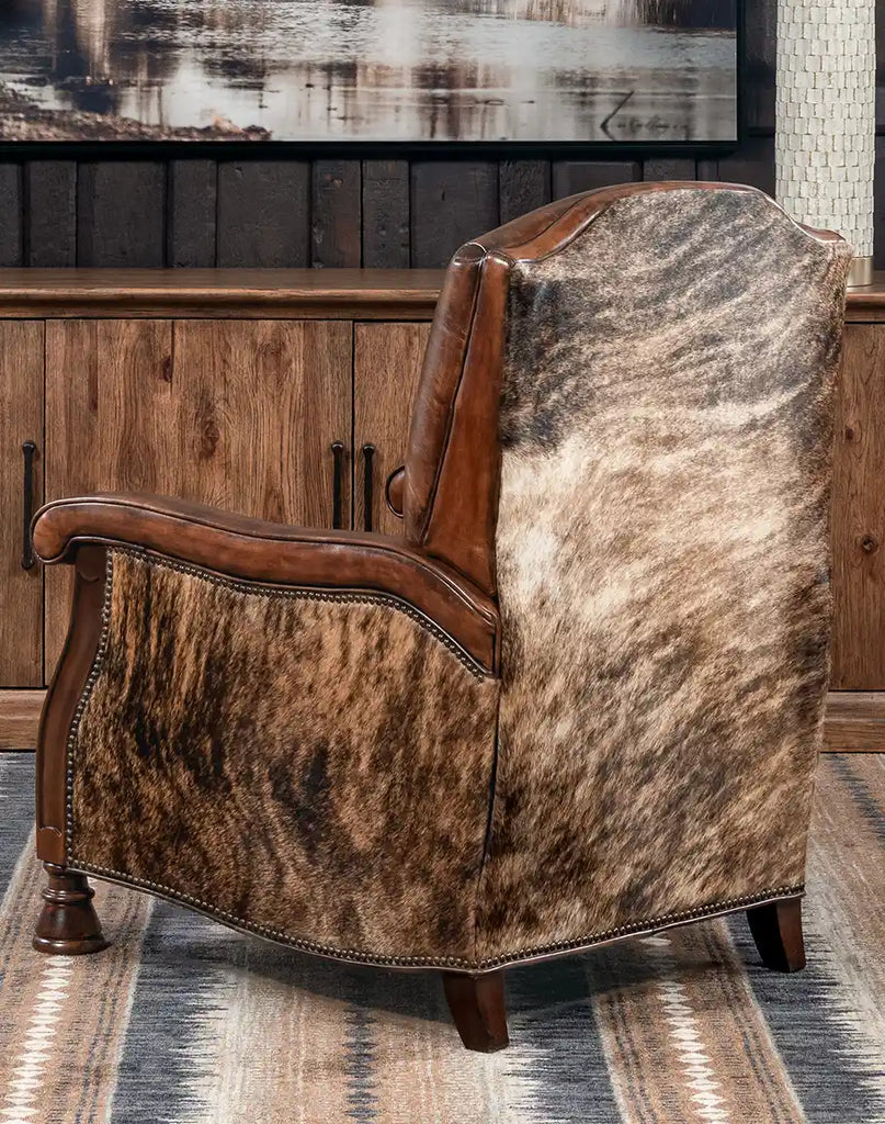 Rear view displaying the brindle cowhide accents on the back panel of the recliner.
