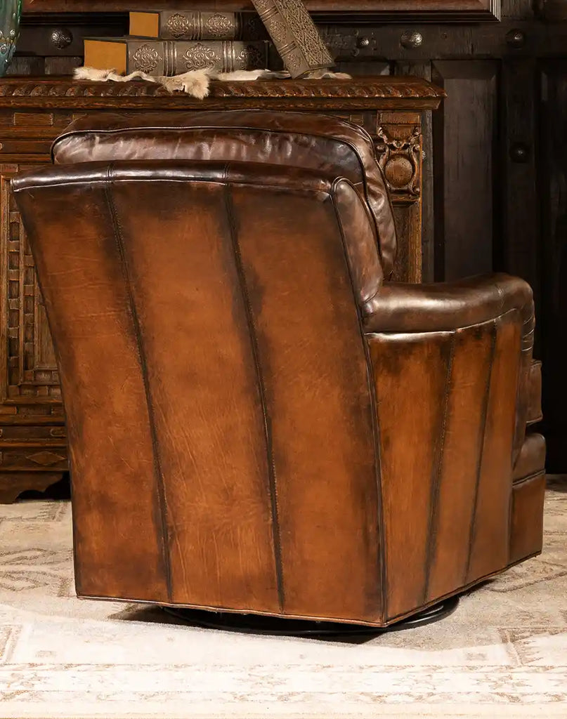 Back view of the Brono Swivel Glider Chair with cowboy boot stitching and nail head accents.