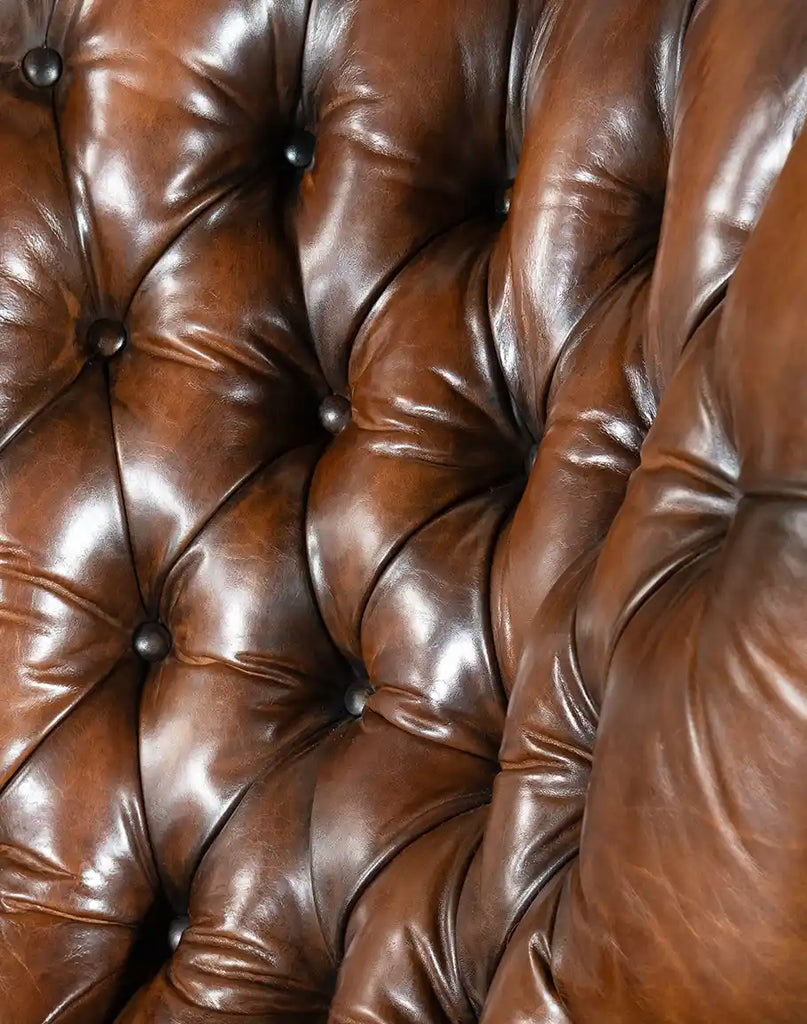 Close-up of the Cameron Leather Recliner's hand-burnished leather, showcasing its premium quality.