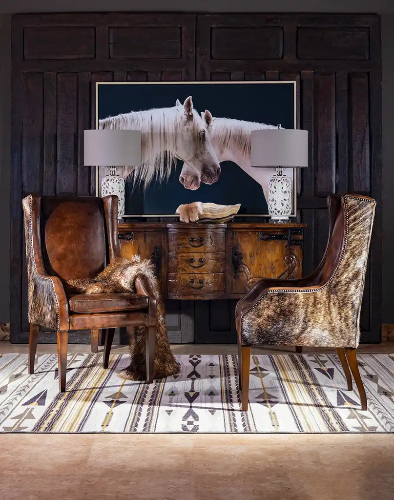 The Cantina Leather Chair placed in a Western-inspired living room, paired with a wooden table and cozy decor.