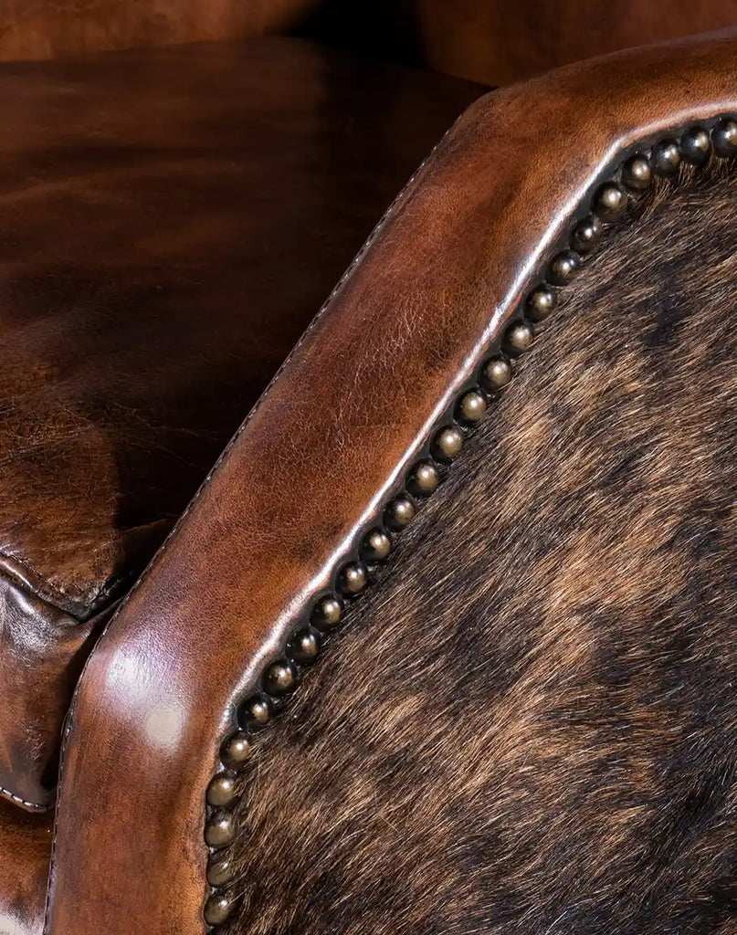 A zoomed-in view of the hand-applied nailhead trim on the Cantina Leather Chair, adding a refined, classic touch.