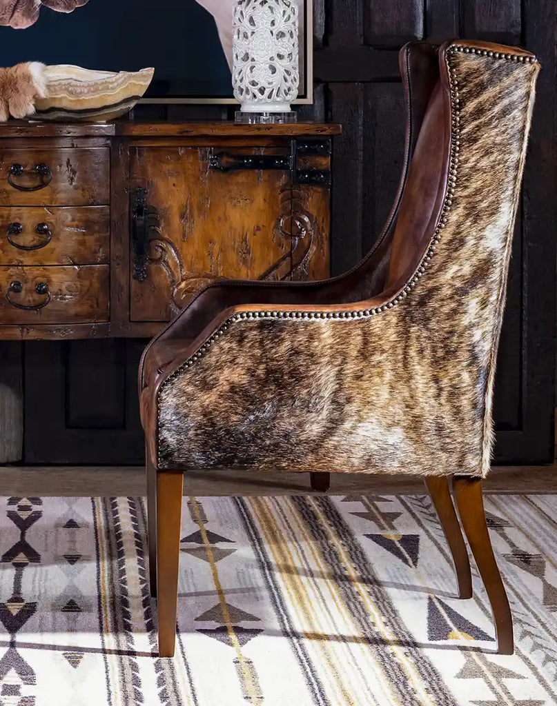 A side profile image of the Cantina Leather Chair, displaying its sturdy wooden legs and high-quality leather upholstery.