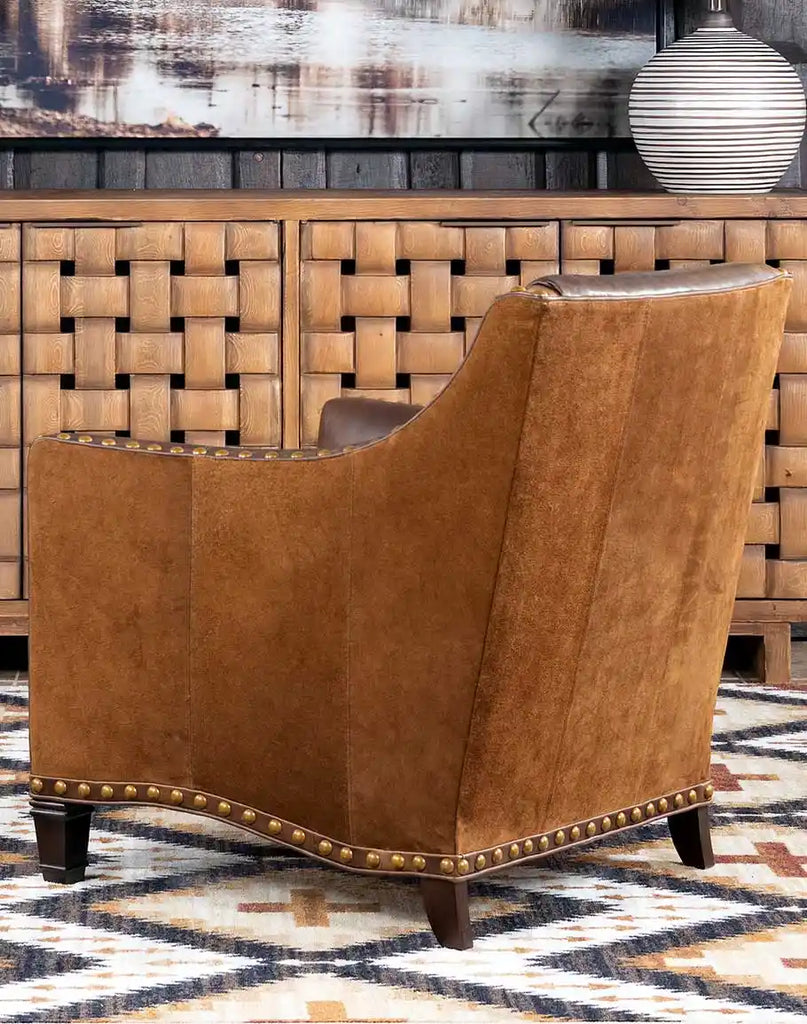 Cassie Brown Leather Chair styled in a rustic living room with complementary wood accents and Western decor.