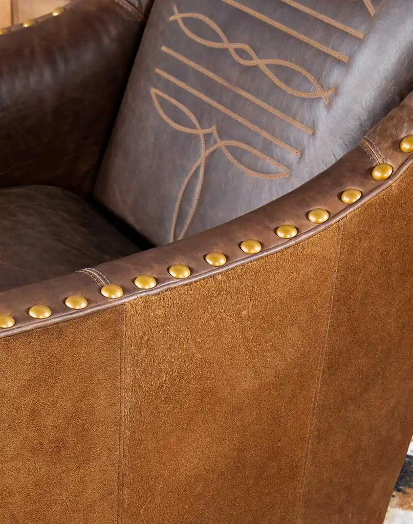 Cassie Brown Leather Chair accented with decorative brass nailhead trim for a classic look.