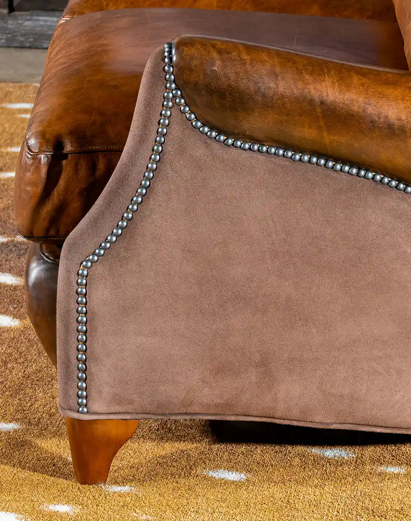 A detailed shot of the nickel nail trim, providing a sophisticated contrast to the rich leather upholstery.