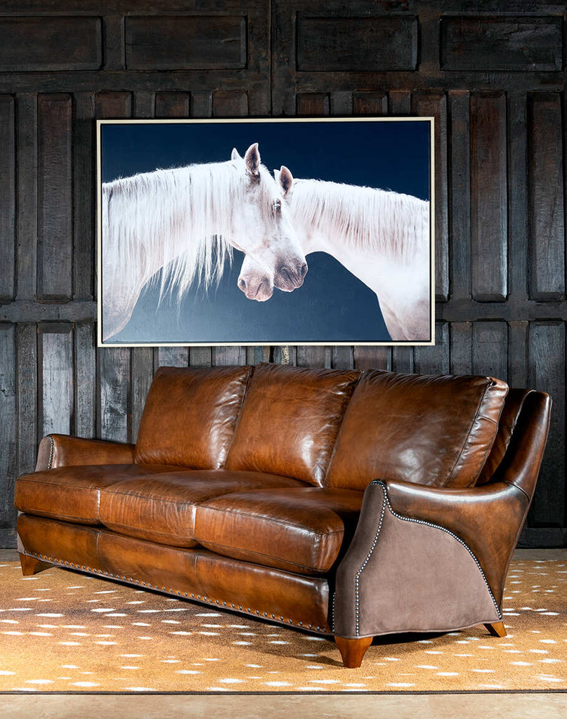 Angled side view of the Cayote Leather Sofa, highlighting its nickel nail trim and hand-burnished leather details.