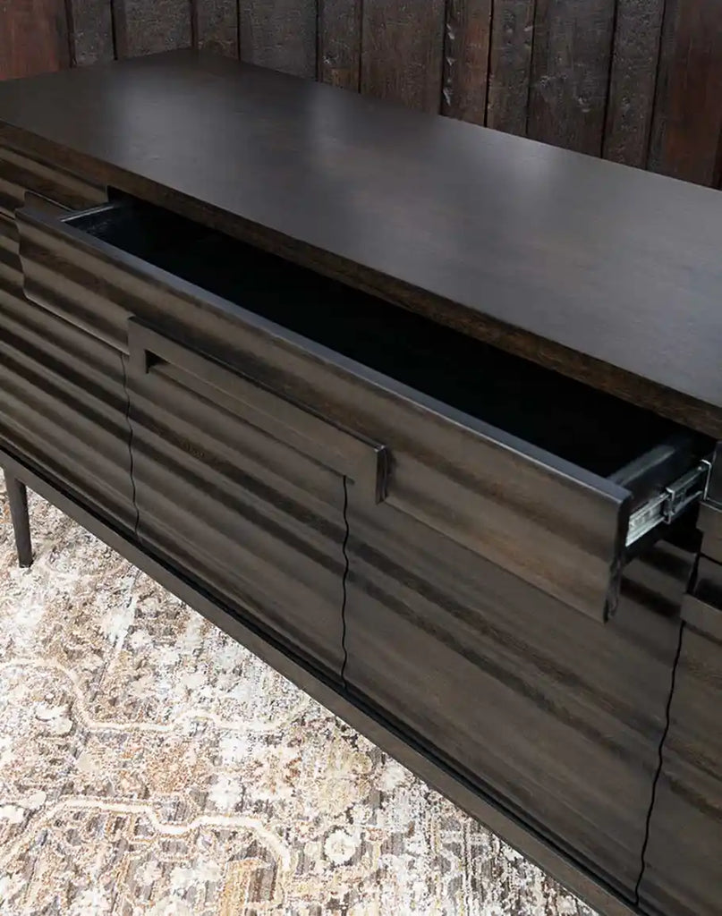 A drawer of the Charcoal Cascade Buffet shown open, providing a look at its spacious interior for storing dining or household essentials.