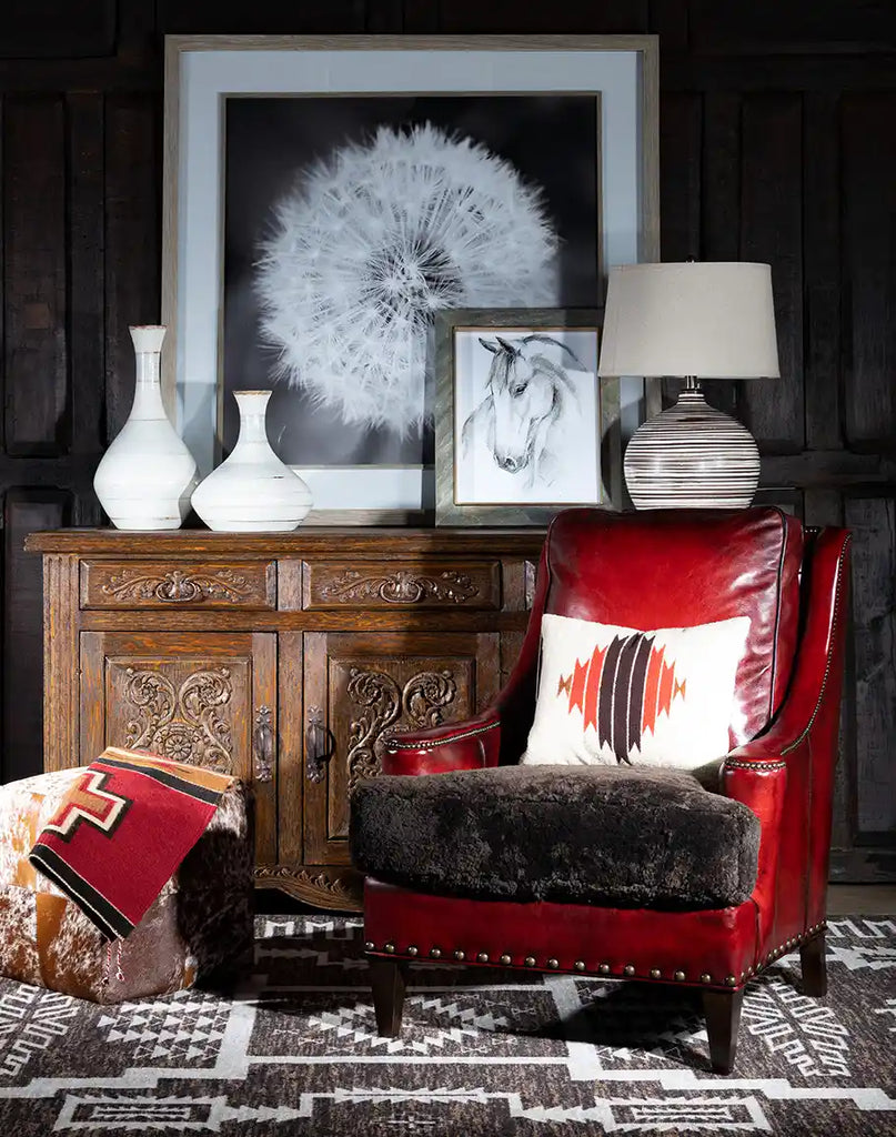 The Cherry Red Leather Chair styled in a cozy living room setting, showcasing its rustic yet modern appeal.