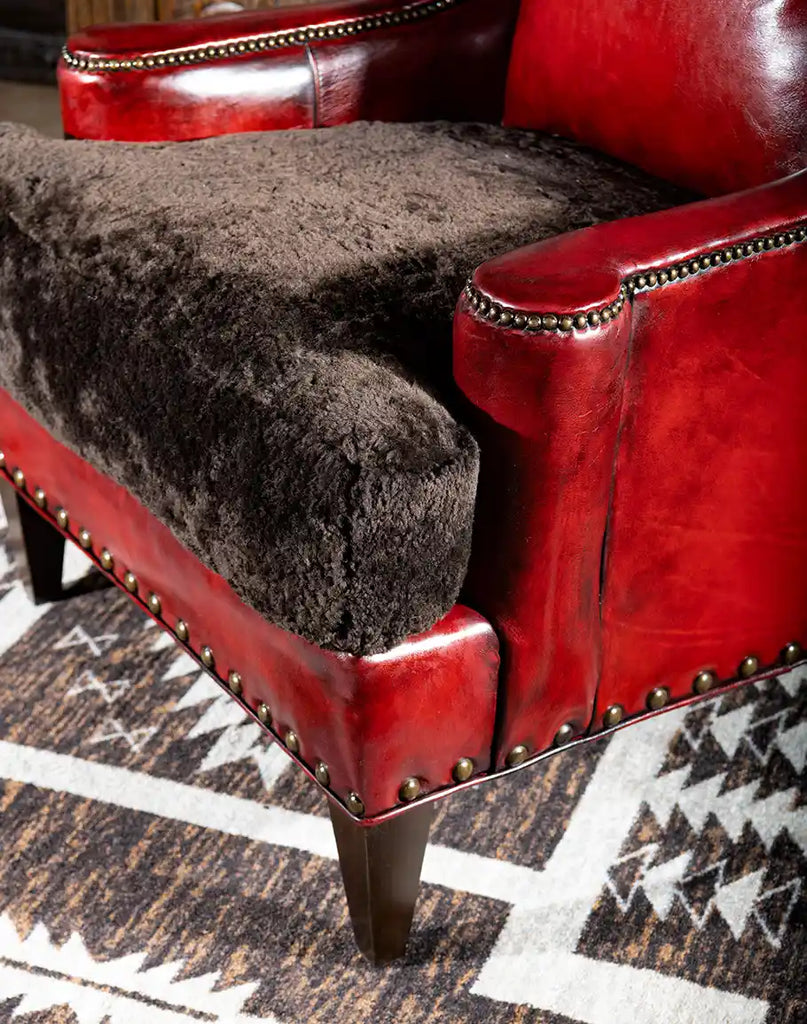 Close-up of the Cherry Red Leather Chair’s sturdy wooden legs, designed for durability and aesthetic appeal.