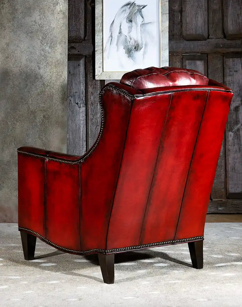 Angled back-facing view of the Cherry Wine Leather Chair, showing off its hand-tanned leather craftsmanship and high-quality stitching.