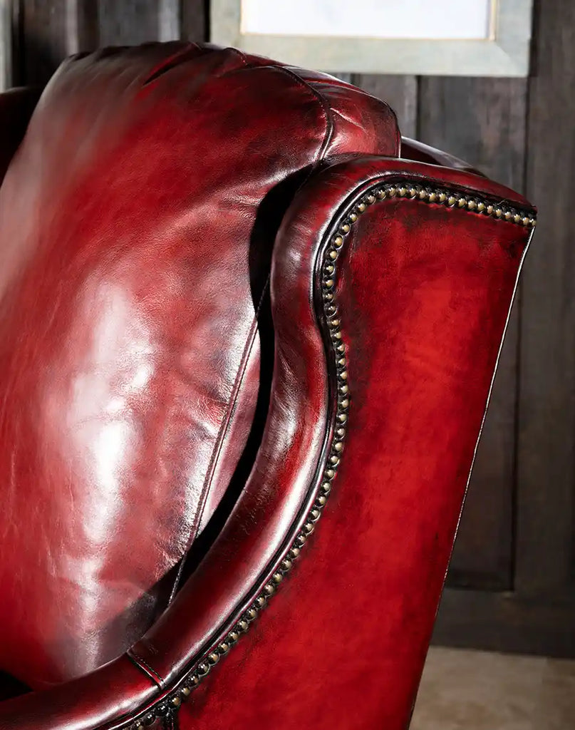 A detailed shot of the Cherry Wine Leather Chair’s artisan leather, showcasing its hand-burnished finish and rich texture.