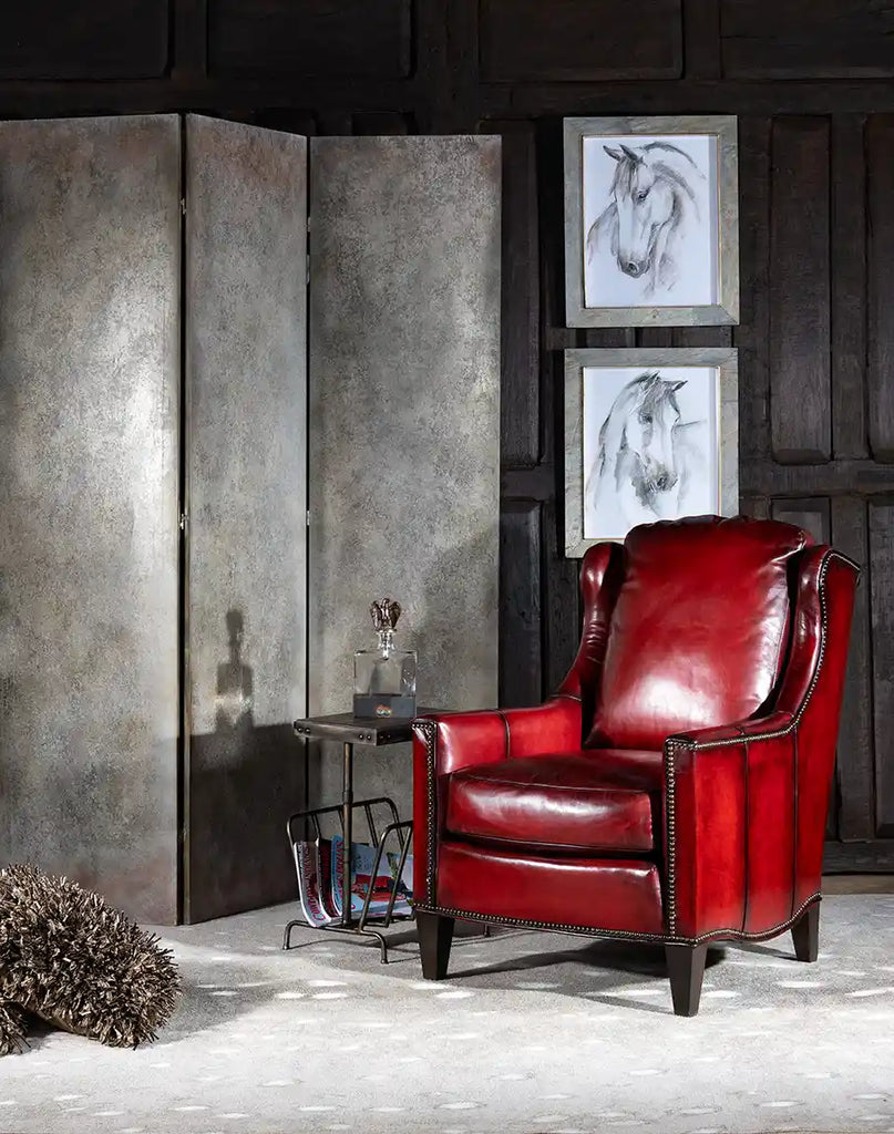 The Cherry Wine Leather Chair placed in a luxurious living room setting, complementing rustic and modern decor styles.