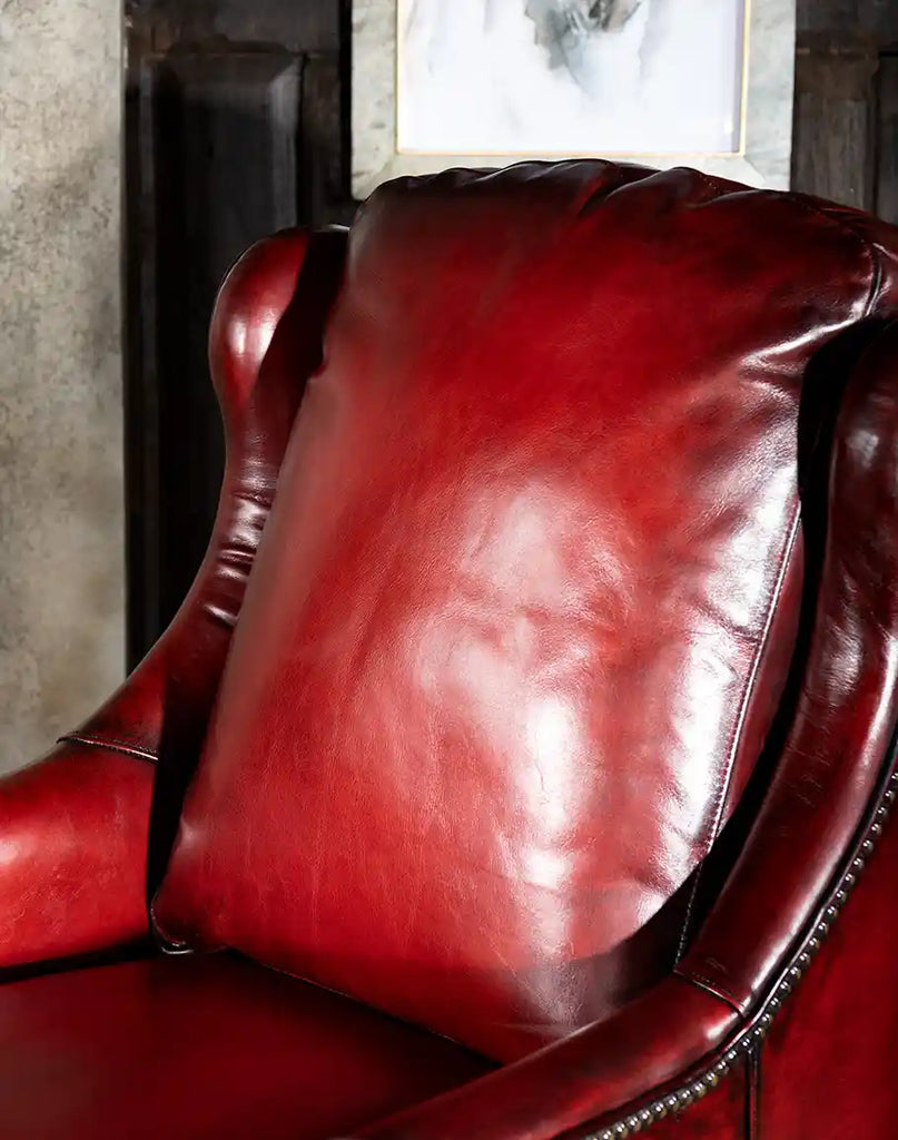 A close-up of the Cherry Wine Leather Chair’s plush pillow back and seat cushion, ensuring superior comfort and support.