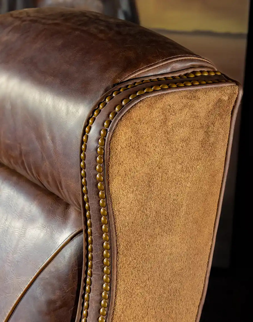 Close-up of the brass nail tacks with gold finish on the Chestnut Brown True Grit Executive Desk Chair reflecting quality craftsmanship.