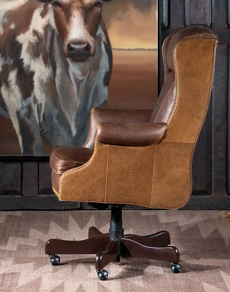 Side profile of the Chestnut Brown True Grit Executive Desk Chair highlighting the ergonomic wingback silhouette and leather suede accents.