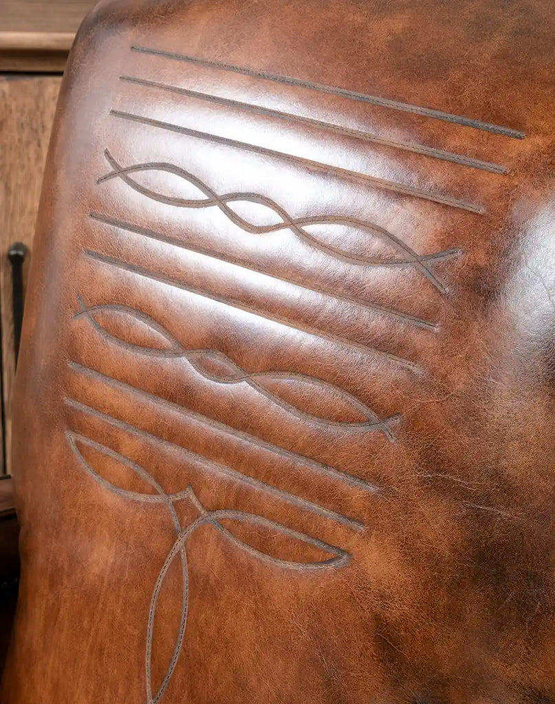 A detailed close-up of the intricate boot stitch embroidery on the recliner’s backrest.