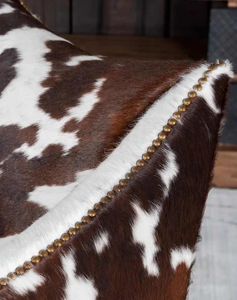 A close-up of the Ebony Cowhide Chair's unique brindle cowhide upholstery, emphasizing its natural textures and rich color patterns.