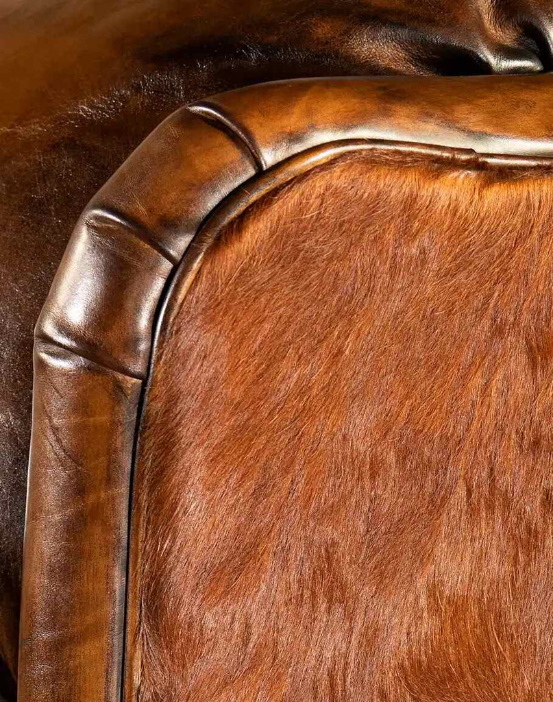 Detailed view of the Scottie Leather Recliner, showing rich artisan leather trim paired with genuine cowhide for a luxurious Western-style finish.